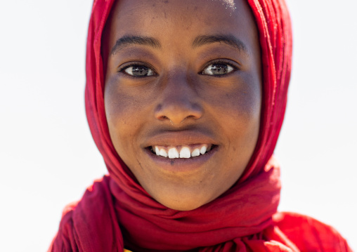 Portrait of an ethiopian teenage girl from  the highlands with a red scarf, Oromia, Sheno, Ethiopia