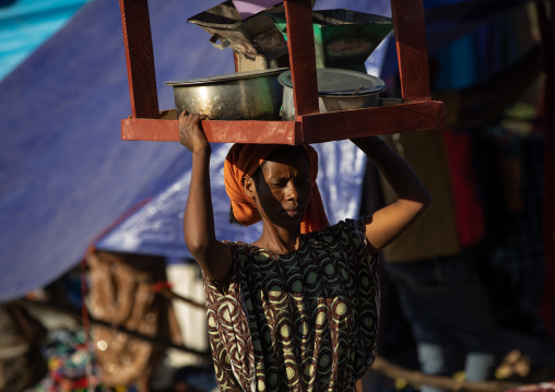 Ethiopian wman carrying a table on her head, Amhara region, Senbete, Ethiopia