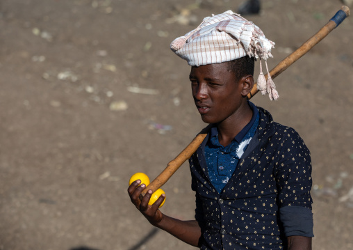 Oromo teenage boy with a stick, Amhara region, Senbete, Ethiopia