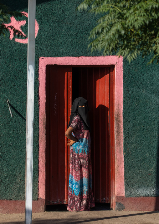 Oromo woman wearing a burqa at the entrance of her house, Amhara region, Senbete, Ethiopia