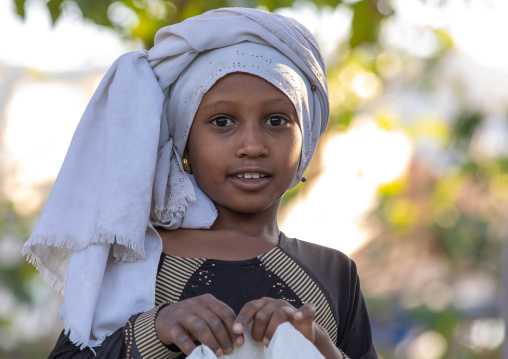 Oromo girl with a headwear in a market, Amhara region, Senbete, Ethiopia
