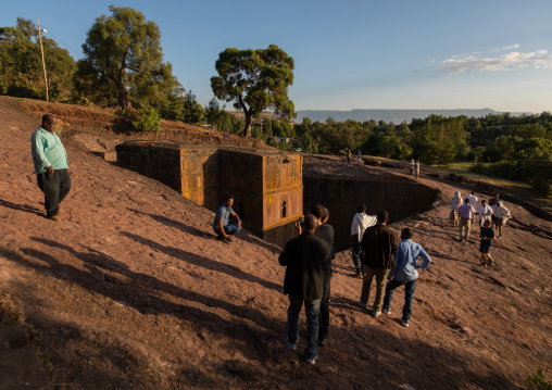 Tourists around the monolithic rock-cut church of bete giyorgis, Amhara Region, Lalibela, Ethiopia