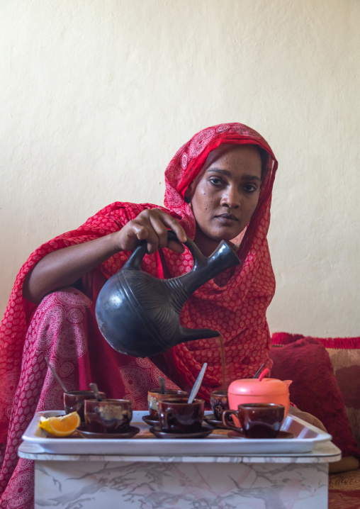 Ethiopian woman serving traditional coffee, Afar Region, Assayta, Ethiopia