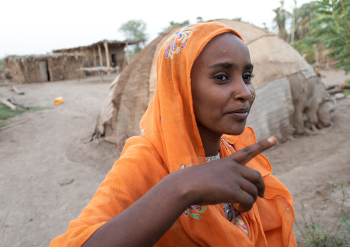 Portrait of an afar tribe woman with orange veil, Afar Region, Afambo, Ethiopia