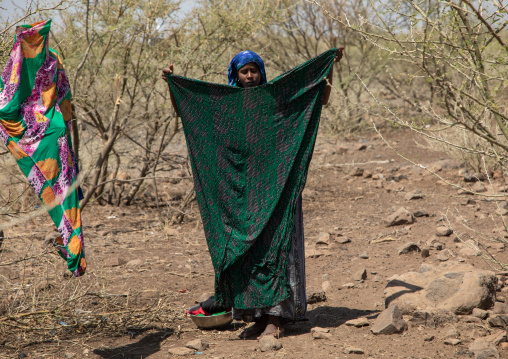 Somali woman drying clothes in an arid area, Afar Region, Gewane, Ethiopia