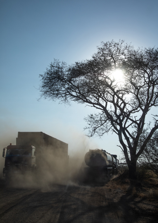 Trucks coming from djibouti port on a dusty road, Oromia, Awash, Ethiopia