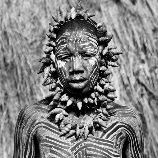 Mursi Tribe Woman With Her Face And Body Painted And Some Shell Ornaments, Omo Valley, Ethiopia