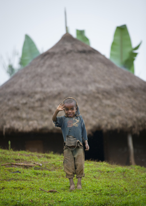 Boy Waving At Camera In Front Of His House, Hossana, Omo Valley, Ethiopia