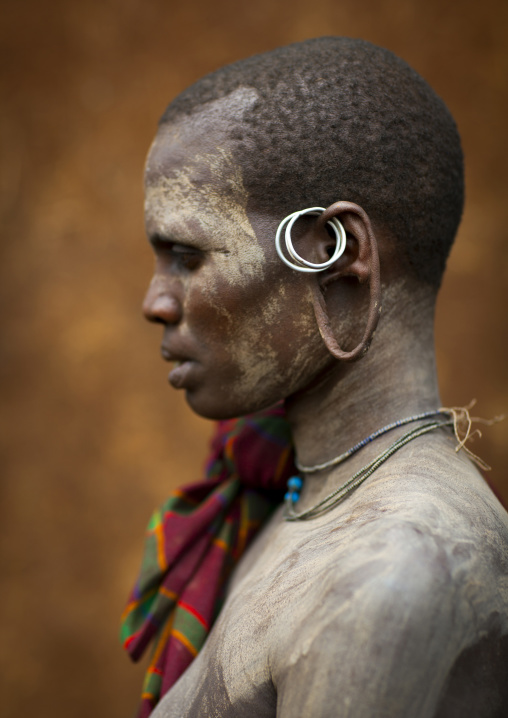 Suri tribe woman with an enlarged earlobe and painted face, Kibish, Omo valley, Ethiopia