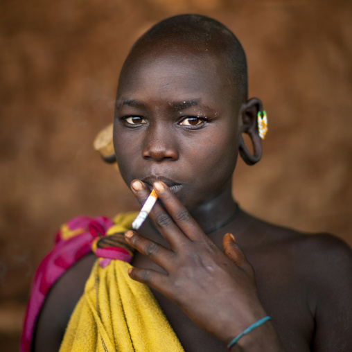 Suri Tribe Girl Smoking, Kibish, Omo Valley, Ethiopia