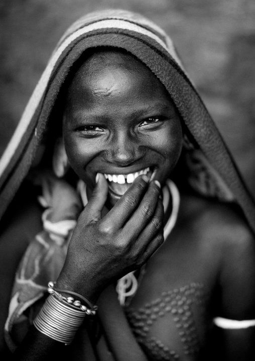 Smiling Suri tribe woman with traditional scarifications, Kibish, Omo valley, Ethiopia