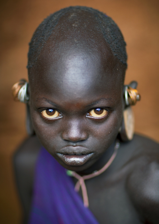 Suri tribe girl with enlarged earlobes, Kibish, Omo valley, Ethiopia