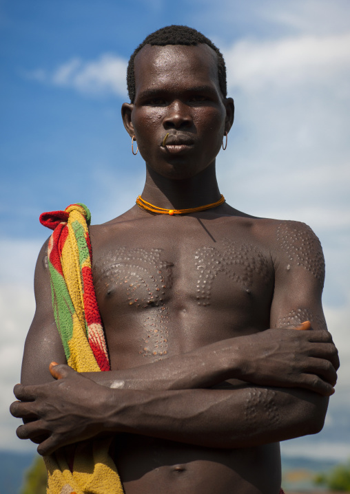 Suri tribe man with scarifications, Kibish, Omo valley, Ethiopia