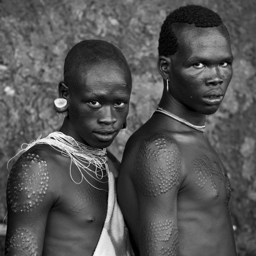 Suri tribe men with scarifications, Kibish, Omo valley, Ethiopia