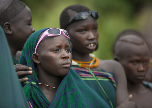 Suri tribe girls wearing sunglasses, Kibish, Omo valley, Ethiopia