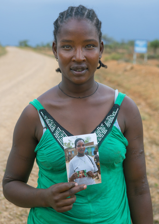 Hamer Tribe Woman Holding A Picture Of Her Taken Two Years Ago, Turmi, Omo Valley, Ethiopia