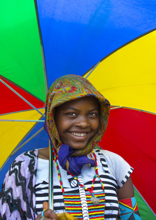 Bana tribe girl under a colouful umbrella, Key afer, Omo valley, Ethiopia