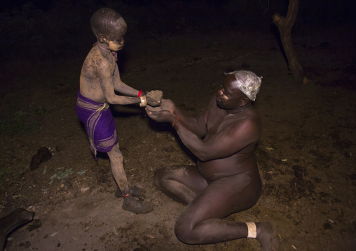 Bodi Tribe Child Putting Ashes On His Fat Father, Hana Mursi, Omo Valley, Ethiopia