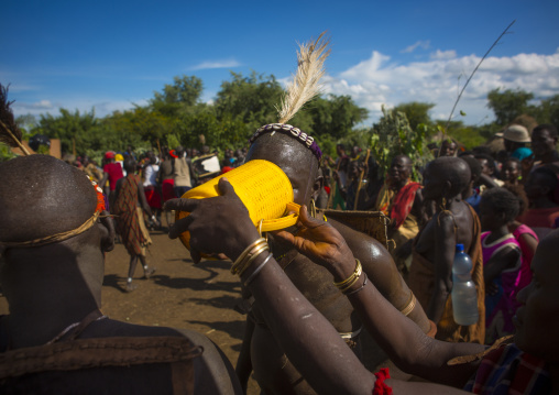 Bodi Tribe Giving  Water To A Fat Man During Kael Ceremony, Hana Mursi, Omo Valley, Ethiopia