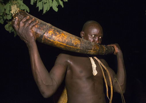 Bodi Tribe Man Blowing In An Elephant Tusk During The Kael Ceremony, Hana Mursi, Omo Valley, Ethiopia