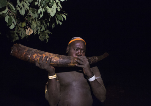Bodi Tribe Man Blowing In An Elephant Tusk During The Kael Ceremony, Hana Mursi, Omo Valley, Ethiopia
