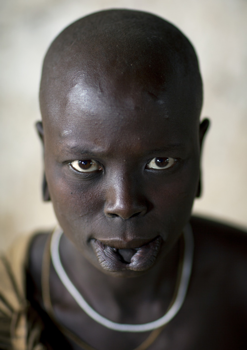 Portrait Of A Young Mursi Tribe Woman With Enlarged Lip In Mago National Park, Omo Valley, Ethiopia