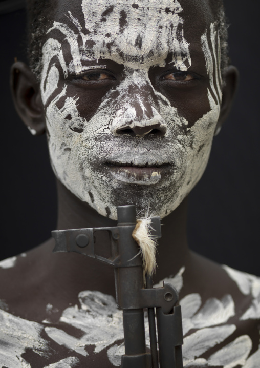 Karo Painted Face With White Paint And Kalashnikov Rifle Barrel Portrait Ethiopia