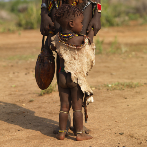 Little Hamer Boy Wearing Skin And Mother Outdoors Ethiopia
