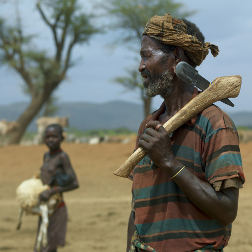 Senior tsemay tribe man with axe on his shoulder, Omo valley, Ethiopia