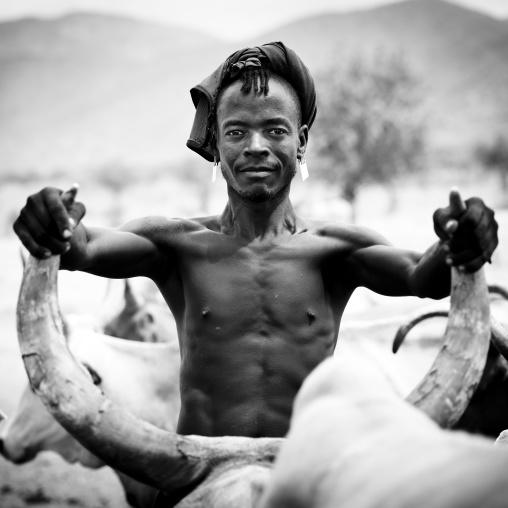 Proud tsemay tribe man holding buffalo horns, Omo valley, Ethiopia