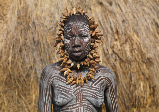 Shell Belt Mursi Woman With White Paint On Body Stands In Front Of Hut Ethiopia