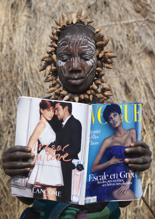 Mursi Man Wearing Shell Necklace Reading Vogue Magazine Ethiopia