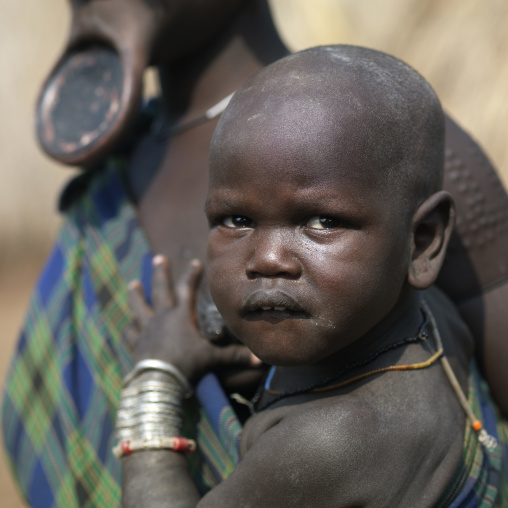Baby Face In Arms Of His Mursi Mother Ethiopia