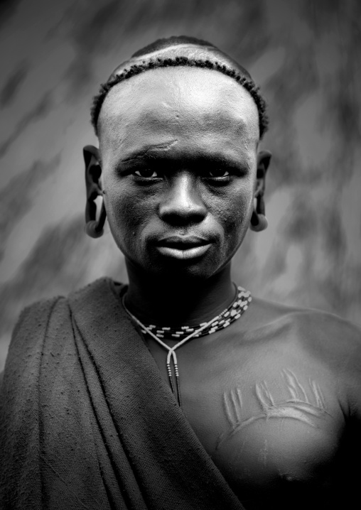 Black And White Portrait Of A Surma Tribe Warrior With Scarifications, Omo Valley, Ethiopia