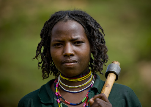 Portrait Of Young Borana Tribe Woman Carrying Axe And Beaded Jewels, Omo Valley, Ethiopia
