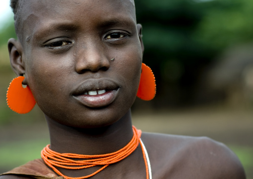 Portrait Of A Young Bodi Tribe Girl With Orange Jewels, Hana Mursi, Omo Valley, Ethiopia