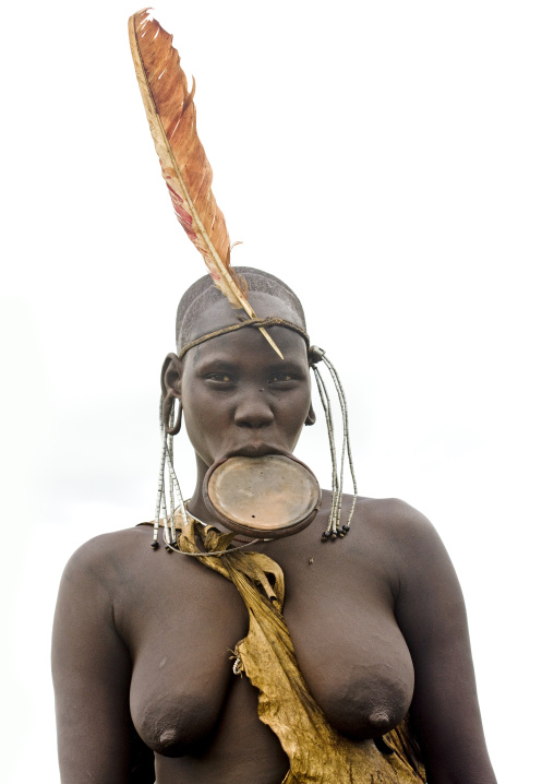 Mursi Woman With Feather On Head And Naked Breasts And Lip Plate On Ethiopia