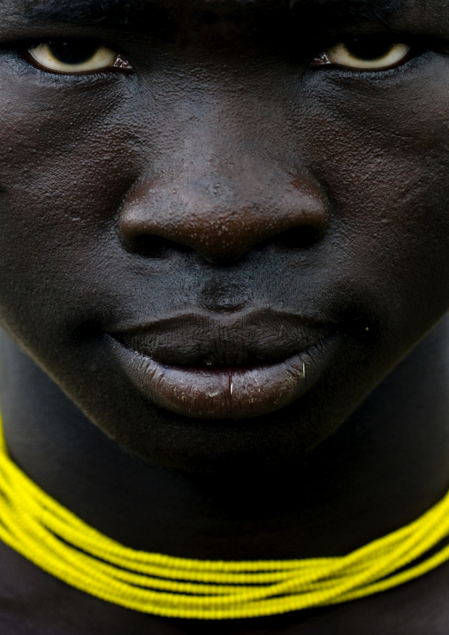 Close Up On The Face Of A Mursi Tribe Man With Yellow Necklace, Omo Valley, Ethiopia