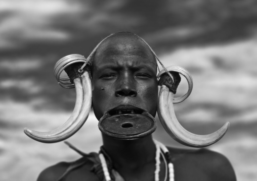 Black And White Portrait Of A Mursi Tribe Woman With Lip Plate And Enlarged Ears In Mago National Park, Omo Valley, Ethiopia