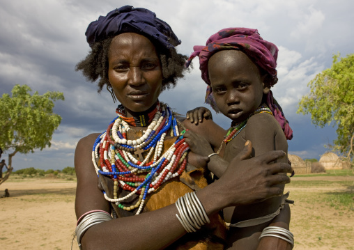Portrait Of An Erbore Tribe Mother With Colourful Necklaces Holding Her Child, Weito, Omo Valley, Ethiopia