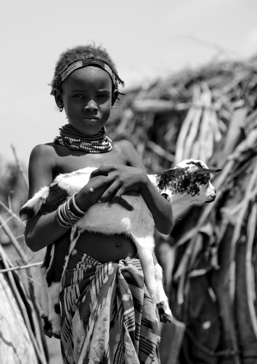 Black And White Portrait Of A Dassanech Tribe Girl With Kid Goat, Omorate, Omo Valley, Ethiopia