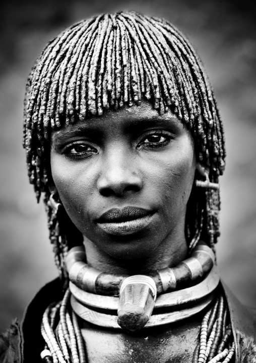 Black And White Portrait Of Hamar Tribe Woman With Traditional Stranded Hair Tied With Clay And Big Necklaces, Turmi, Omo Valley, Ethiopia