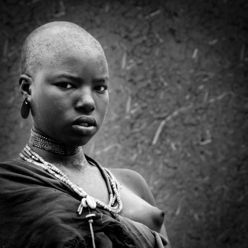 Black And White Portrait Of A Young Uta Hamer Tribe Woman With Strong Expression And Shaved Head, Turmi, Omo Valley, Ethiopia