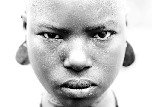 Black And White Close Up On The Face Of A Young Uta Hamar Tribe Girl With Strong Expression And Enlarged Ears, Turmi, Omo Valley, Ethiopia