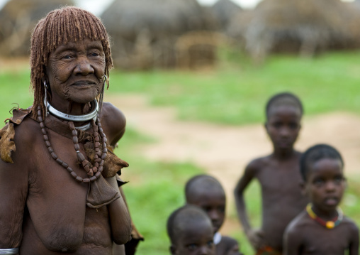 Old Hamar Tribe Woman With Stranded Hair And Necklacers Followed By Kids, Turmi, Omo Valley, Ethiopia