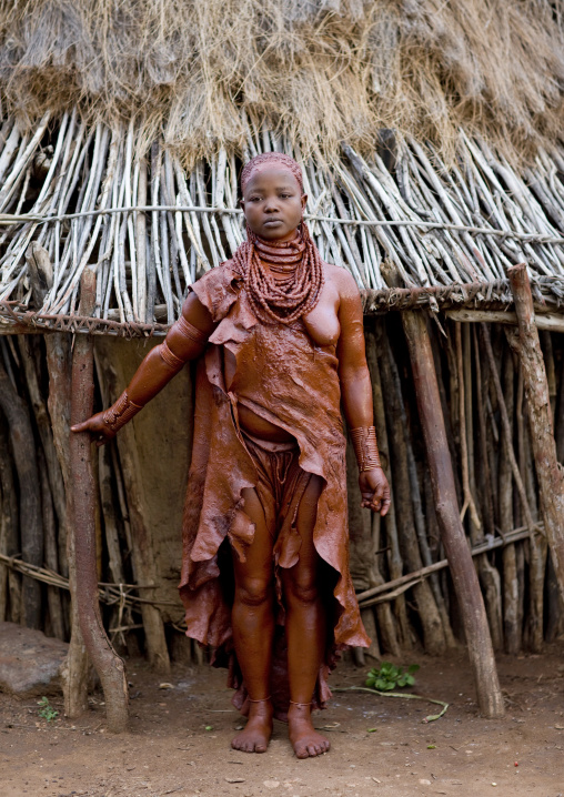 Portrait Of A Uta Hamar Tribe Woman Covered With Red Clay Posing Outside Her Hut, Turmi, Omo Valley, Ethiopia