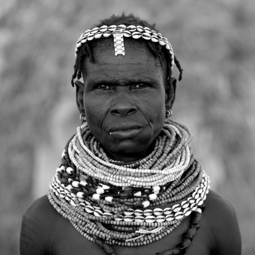 Black And White Portrait Of A Nyangatom Tribe Woman With Huge Traditional Necklaces, Omo Valley, Kangate, Ethiopia