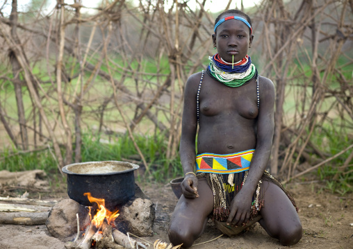 Portrait Of A Nyangatom Tribe Woman Preparing A Meal, Omo Valley, Kangate, Ethiopia