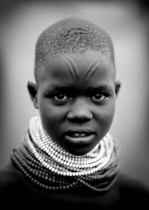 Black And White Portrait Of A Nyangatom Tribe Girl With Big Necklaces And Facial Scarifications, Omo Valley, Kangate, Ethiopia