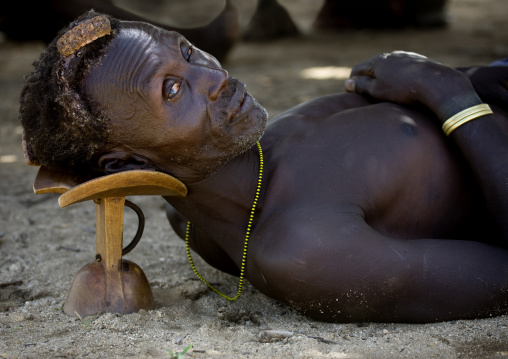 Portrait Of A Karo Man Laying Down On His Headrest, Korcho Village, Omo Valley, Ethiopia